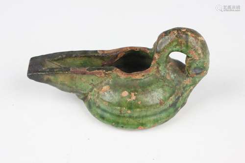 An Islamic green glazed pottery oil lamp