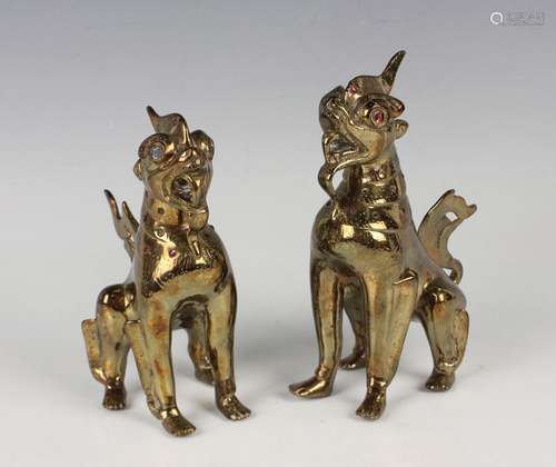 A pair of South-east Asian polished brass models of Buddhist...