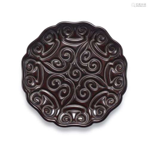 An extremely rare and finely carved black 'tixi' lacquer lob...