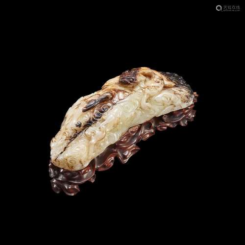 A finely carved white and russet jade 'dragon' brushrest, Yu...