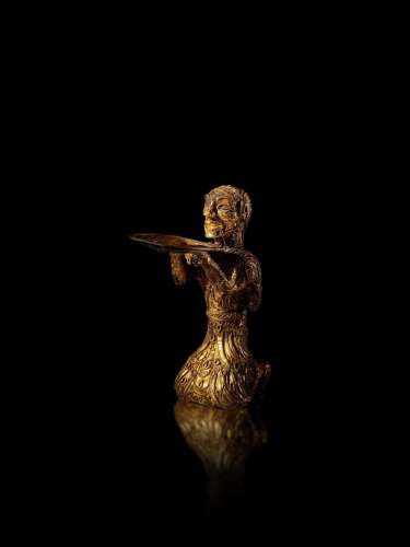 An important and exceedingly rare gold kneeling figure, West...