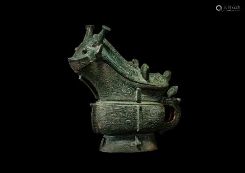 An exceptionally rare archaic bronze ritual wine vessel and ...