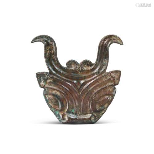 A very rare and important bronze 'bovine' harness frontlet, ...