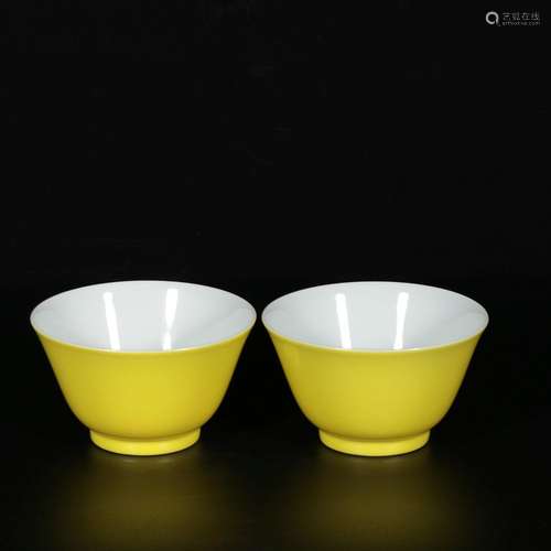 A pair of lemon yellow glaze cups