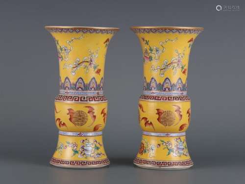 A pair of yellow-ground famille rose goblets with blessings ...