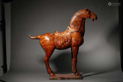 A YELLOW POTTERY HORSE