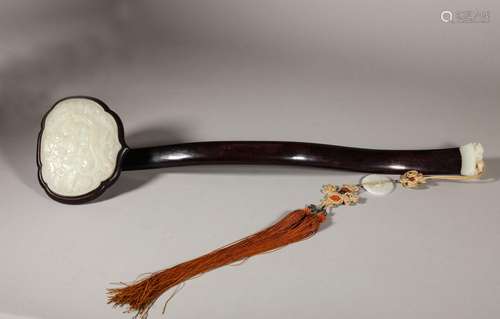 A Qing Dynasty red sandalwood inlaid with white jade Ruyi