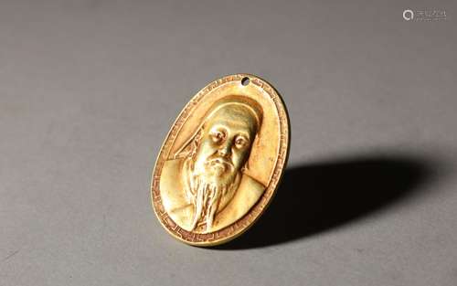 A gold coin with the head of an old figure