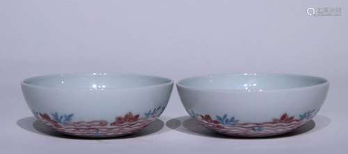 A pair of alum red bowls