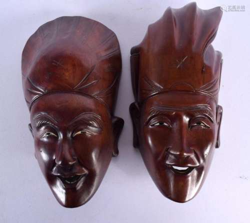 A PAIR OF 19TH CENTURY CHINESE CARVED HARDWOOD MASK HEADS Qi...