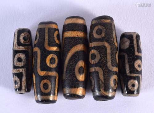 FIVE TIBETAN CARVED AGATE ZHU BEADS. 46.5 grams. Largest 4 c...