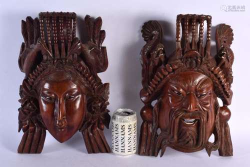 A PAIR OF 19TH CENTURY CHINESE CARVED HARDWOOD MASK HEADS. 3...