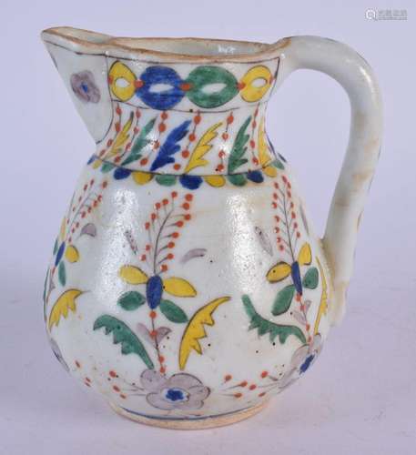 A TURKISH KUTAHYA POTTERY CREAM JUG painted with floral spra...