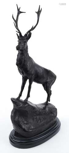 Large patinated bronze stag raised on a black marble base, 7...