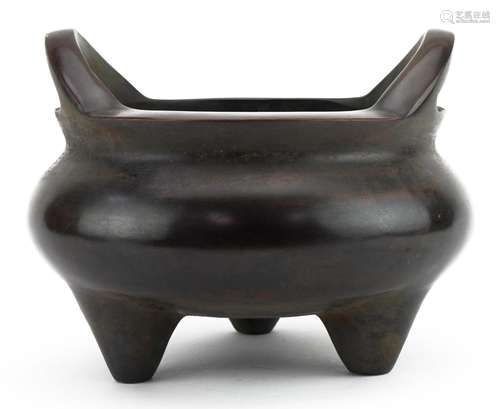 Large Chinese patinated bronze tripod censer with twin handl...