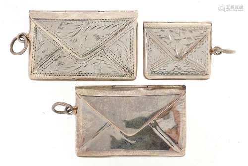 Three silver stamp cases in the form of envelopes, two with ...