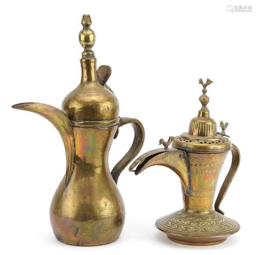 Two Omani brass dallah coffee pots including one with impres...