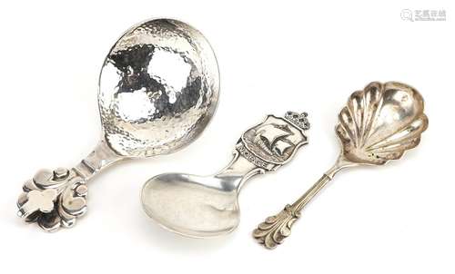 Three decorative arts caddy spoons including one with planis...