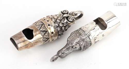 Two silver whistles in the form of a dog and an owl, the lar...