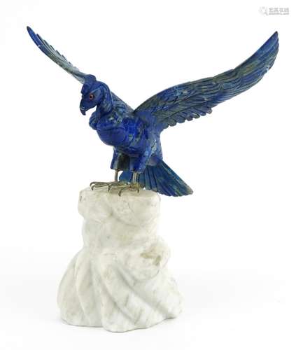 Carved lapis lazuli eagle raised on a carved white marble ro...