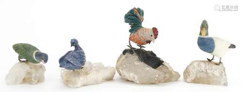 Four carved stone ducks and a cockerel, each raised on rocky...