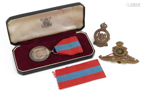 Elizabeth II Faithful Service medal and two cap badges, the ...