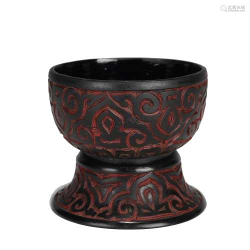 A CARVED RED AND BLACK LACQUER CUP