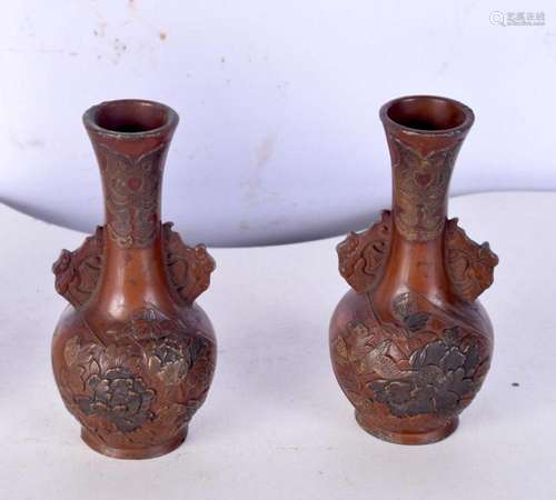 A pair of small Japanese bronze vases decorated in relief wi...