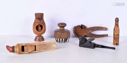 A collection of wooden nut crackers together with a pipe etc...