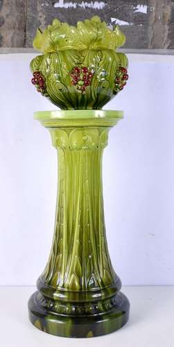 A green glazed Bretby jardiniere on stand, decorated with gr...