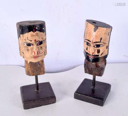 A pair of mid 20th century folk art wooden painted heads, fo...