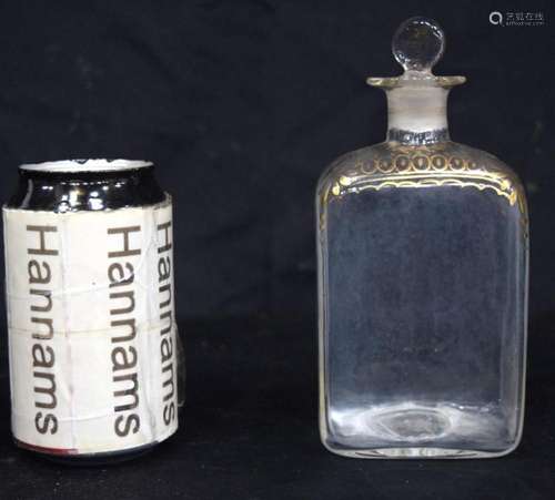 An antique glass ointment bottle decorated with gilt design ...