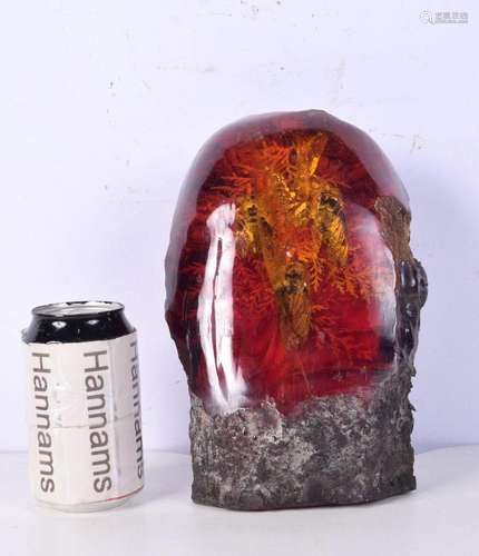 An amber type sculpture with encased bugs 22cm