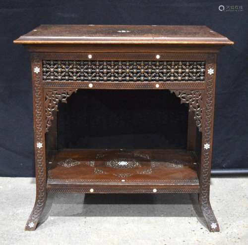 A highly carved 20th Century Syrian two tier table with fine...