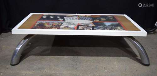 A coffee table with a large Beatles jigsaw of Album covers s...