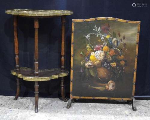 An antique two tier stand with a brass gallery to the shelve...