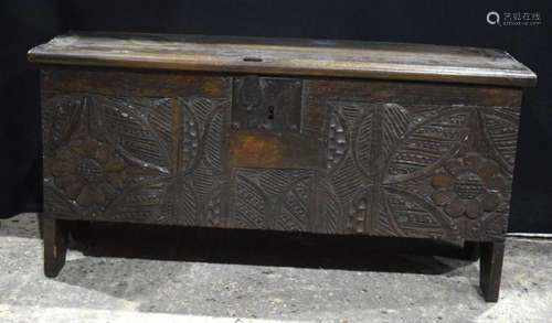 An Arts and Crafts oak chest with carved wood panels to the ...