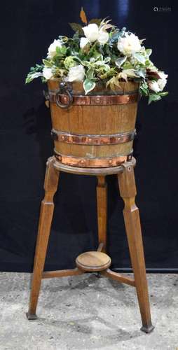 A copper bound wooden tub with a fitted stand 100cm.