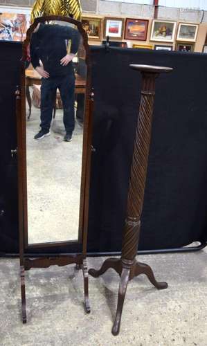 A large framed standing mirror together with large wooden ca...