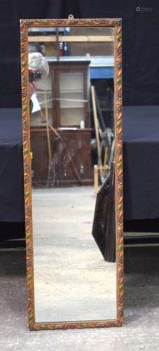 An antique wood and plaster framed mirror decorated with flo...