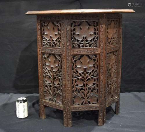 A heavily carved Anglo Indian octagonal folding table 63 cm.