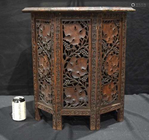 A heavily carved Anglo Indian octagonal folding table 56 x 5...