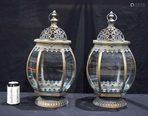 A pair of bronzed open work metal and curved glass panel lan...