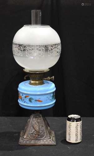 An early 20th Century oil lamp with a porcelain reservoir 58...