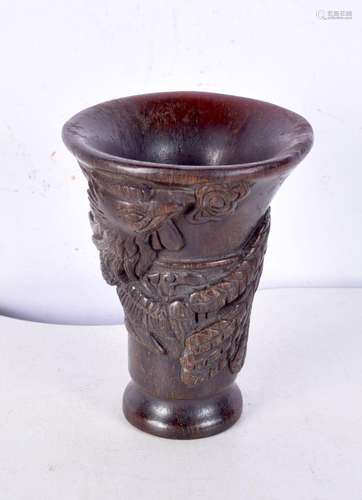 A Chinese horn libation cup type beaker, carved with phoenix...