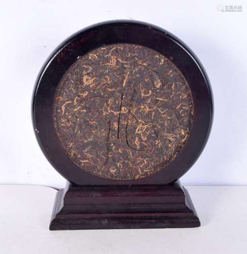 A 20th century Chinese compressed tea leaf circular panel, d...