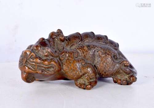 A Chinese bronze scroll weight in the form of a mythical bea...