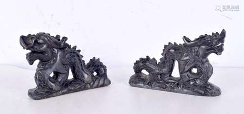 A pair of Chinese carved black hardstone dragons, possibly s...