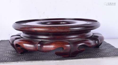 A Chinese carved rosewood stand, lobed in form. 21 cm wide.