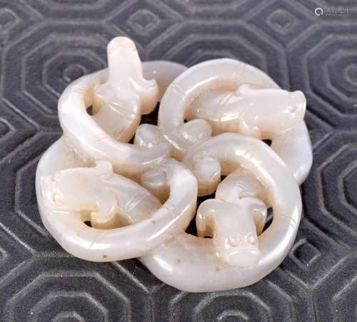 A Chinese celadon jade carved pendant, formed as entwined my...